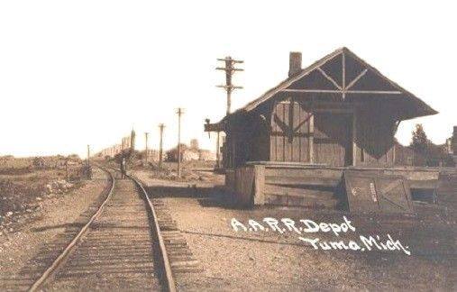 an old black and white po of a train station