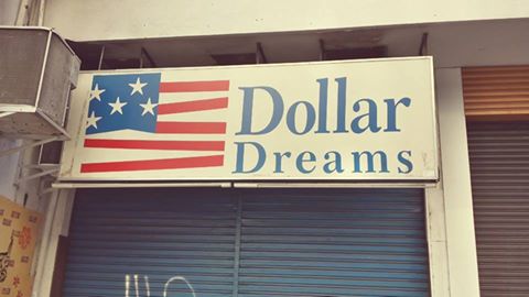 a closed shop front with dollar signs on the windows