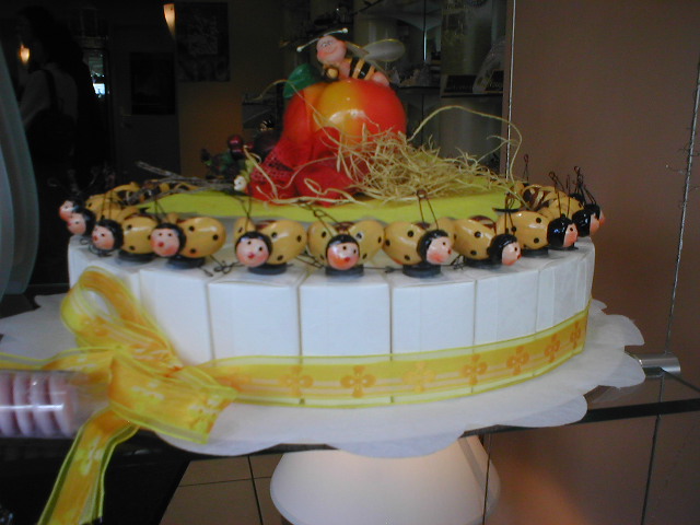 a cake with lots of bees and hay on top