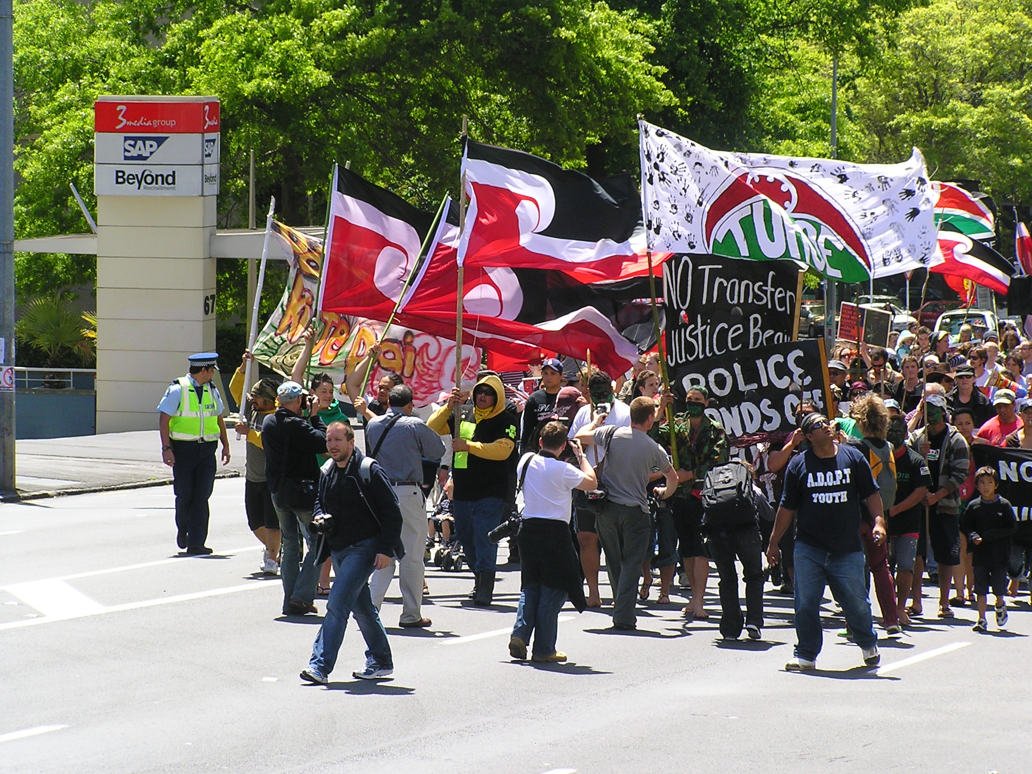 large group of protesters marching on street in protest