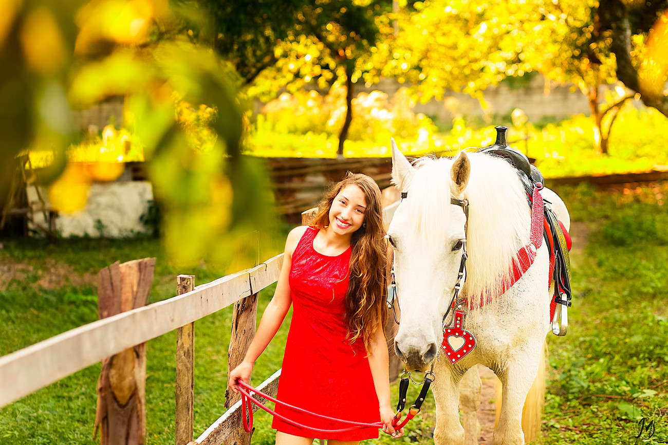 a woman is holding the lead of her horse