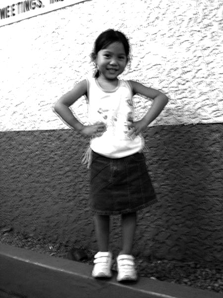 black and white image of little girl posing for camera