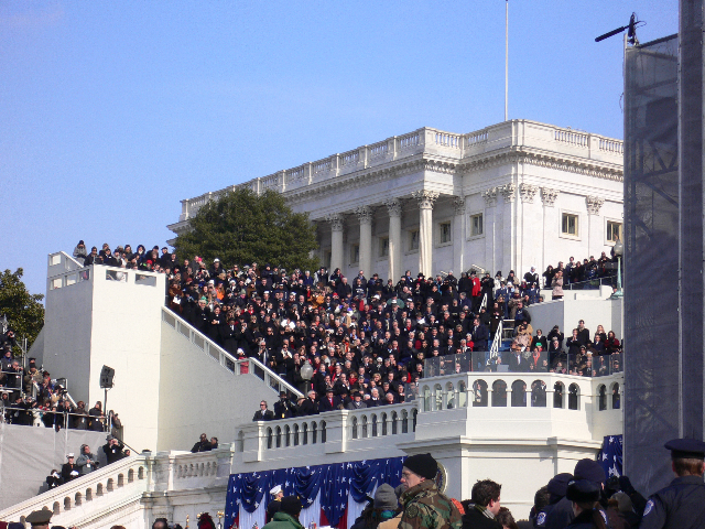 a large crowd watches as someone is standing on the steps