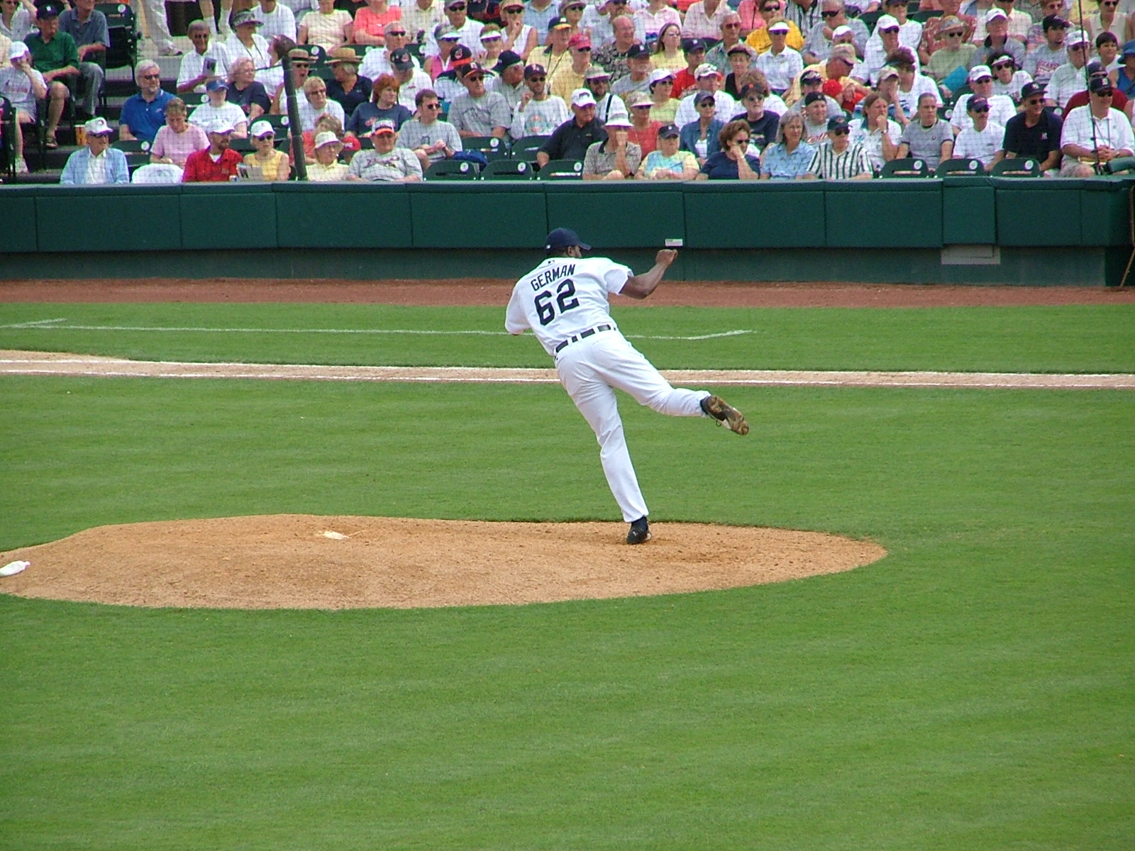 a baseball pitcher winds up to pitch the ball