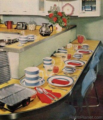 a kitchen with a table with plates and waffle plates