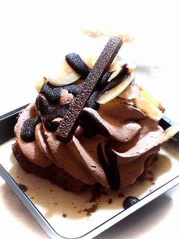 a large cupcake with chocolate toppings on a plate