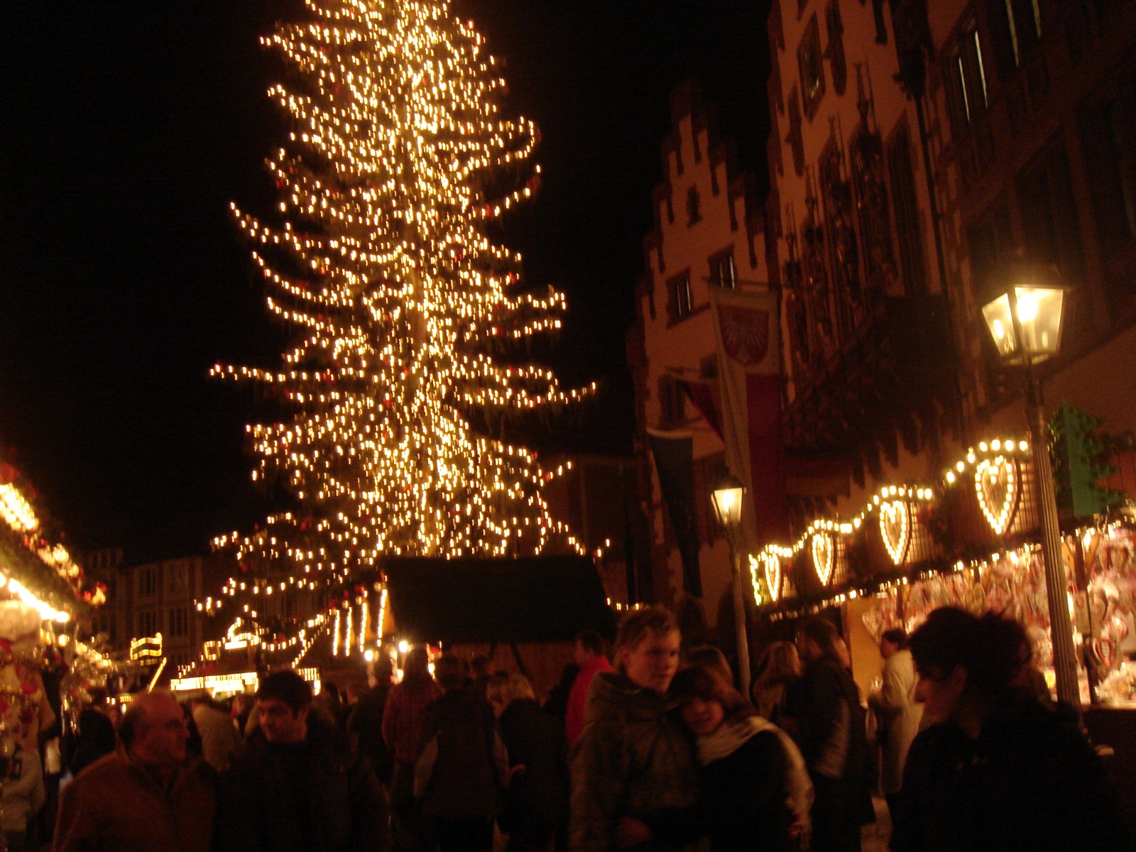 many people are walking down a crowded city street