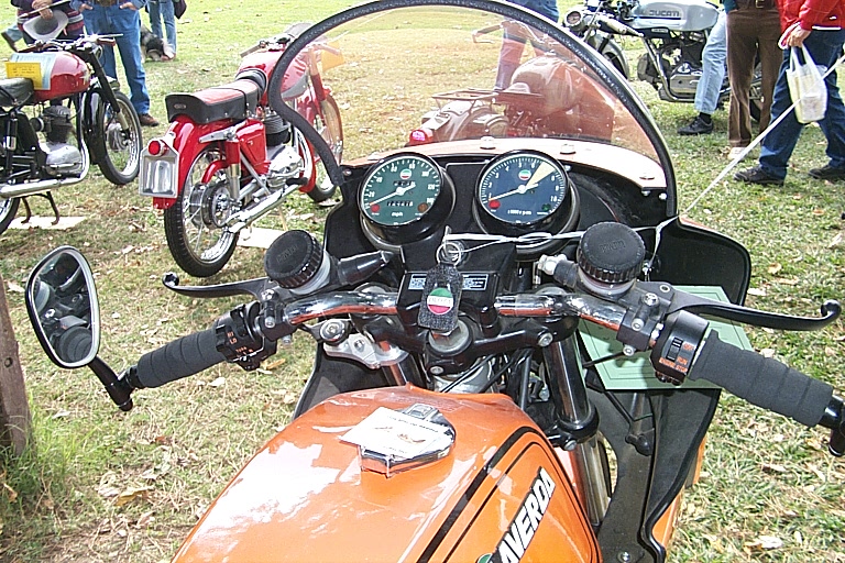 a number of motor bikes parked in a field