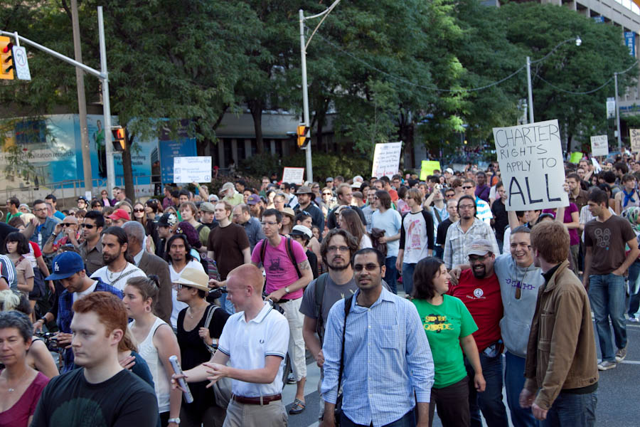 a bunch of people on the street with signs