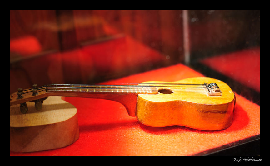 a wooden guitar and a guitar case on a table