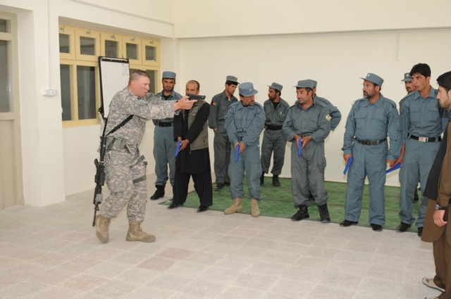 a person in uniform pointing a projector to the army
