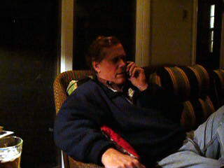 a person is sitting on a couch talking on the phone