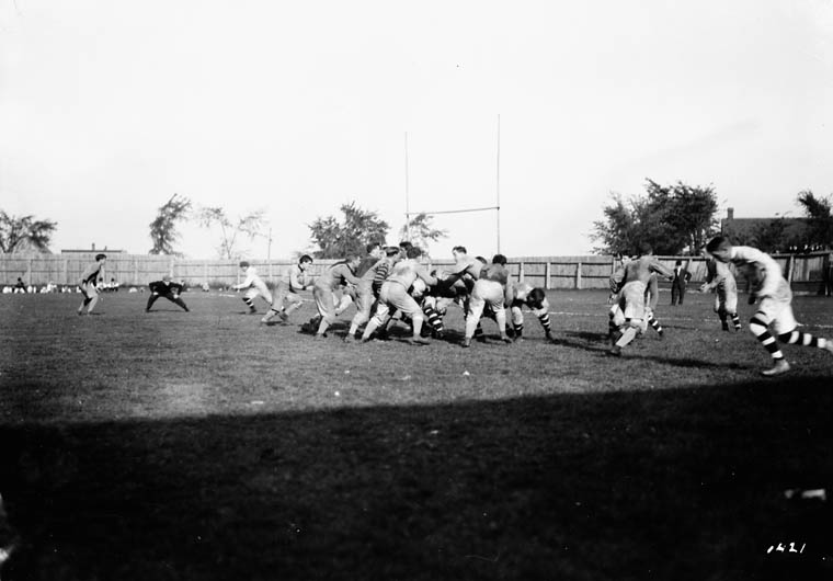 a group of men playing a game of football on a field