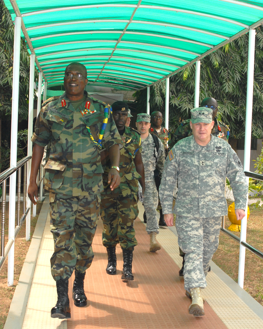 soldiers walking down a path under an awning