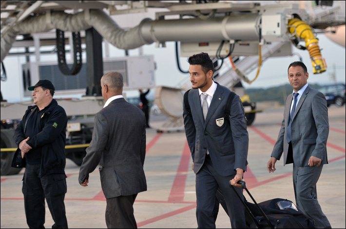 three business men are walking with luggage on a runway