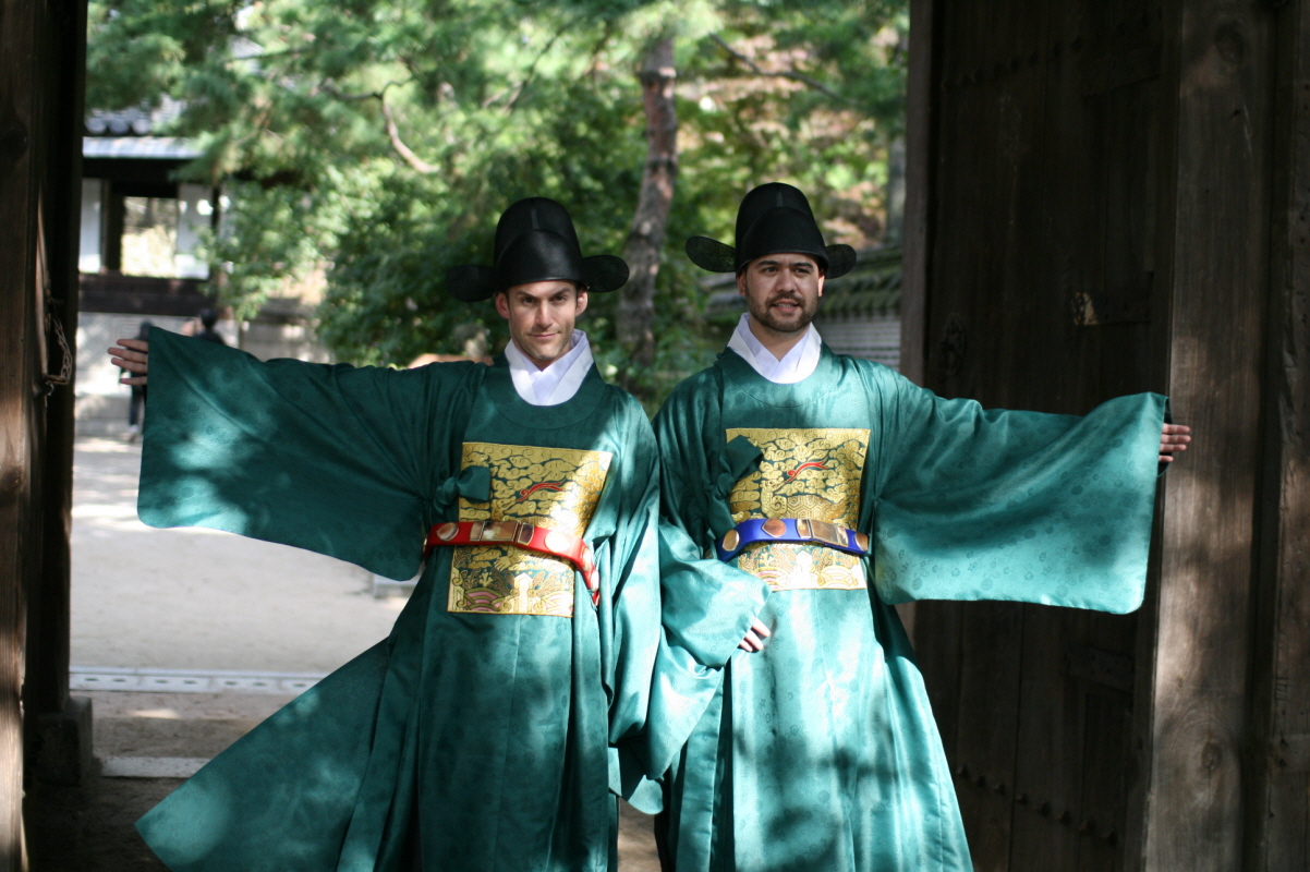 two men dressed in costumes standing beside each other