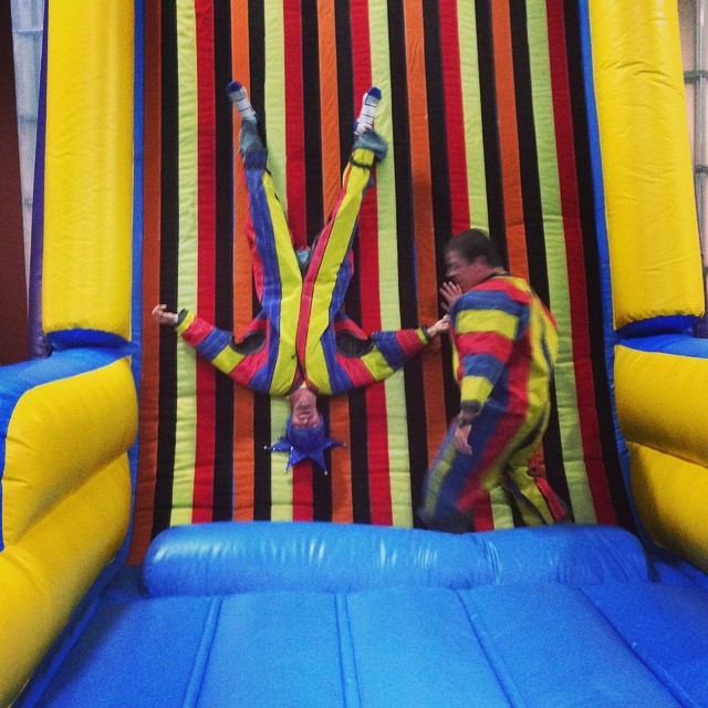 two people are jumping on a bouncy course