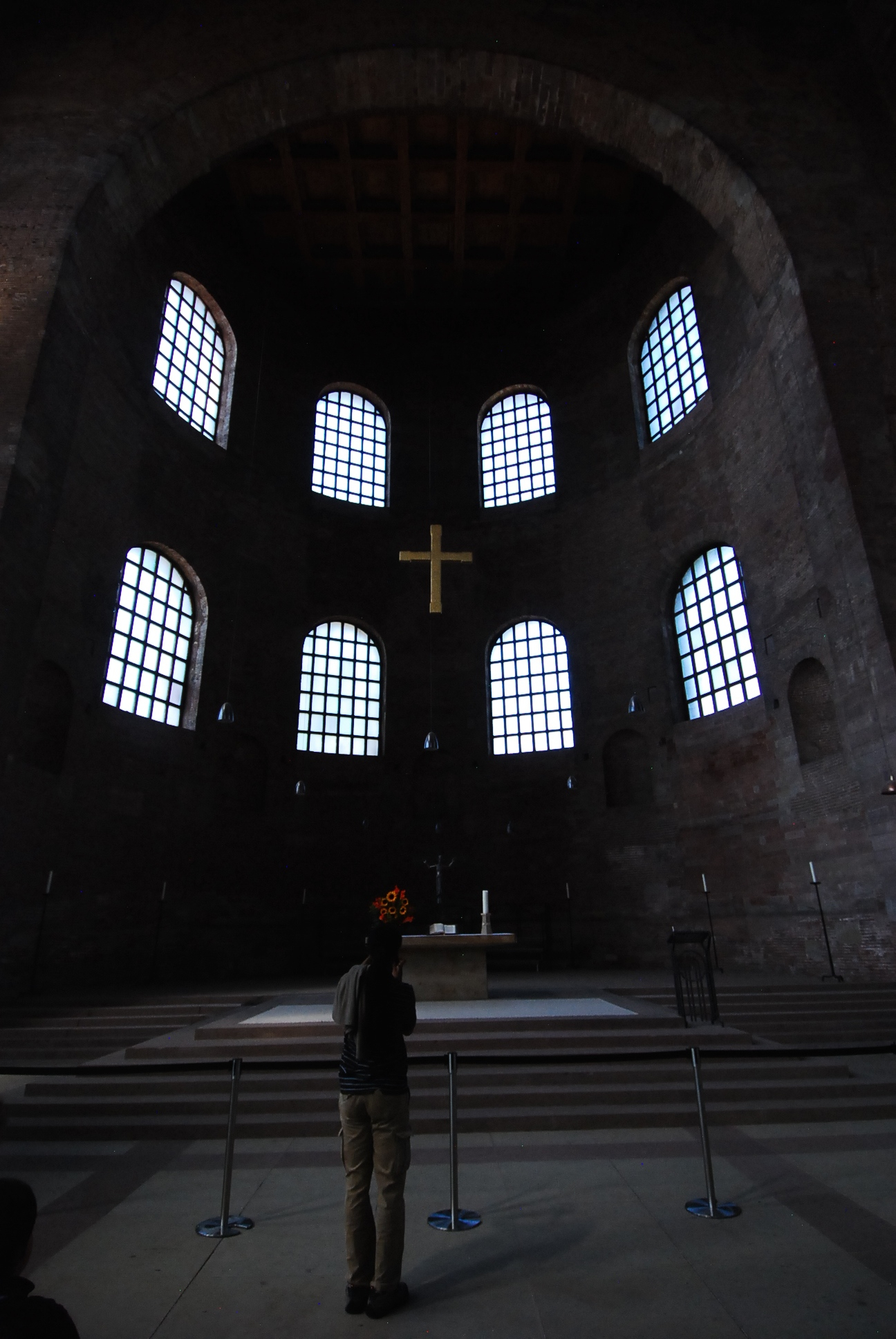 the priest is standing in a church alone