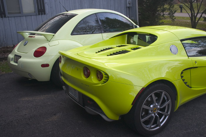 the yellow car is parked next to the white car