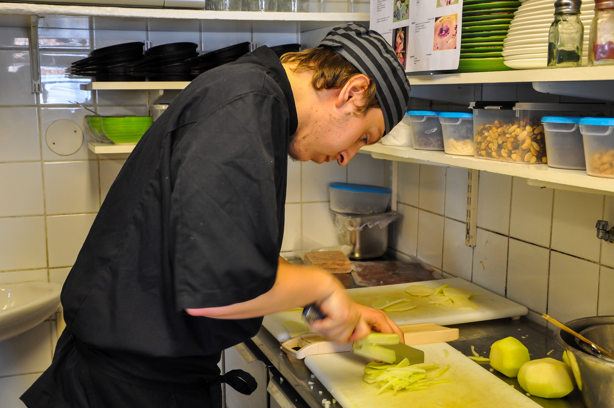 a man standing in a kitchen  up food