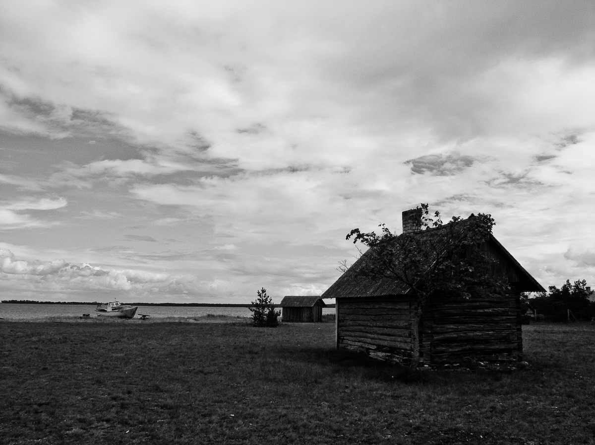 an old house that has a tower and a sky background