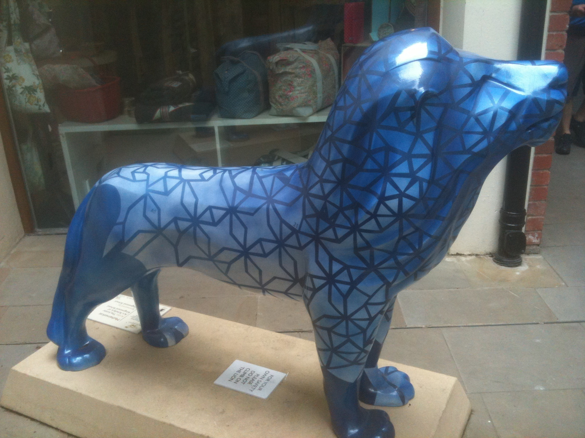 a blue and black animal with intricate details in it