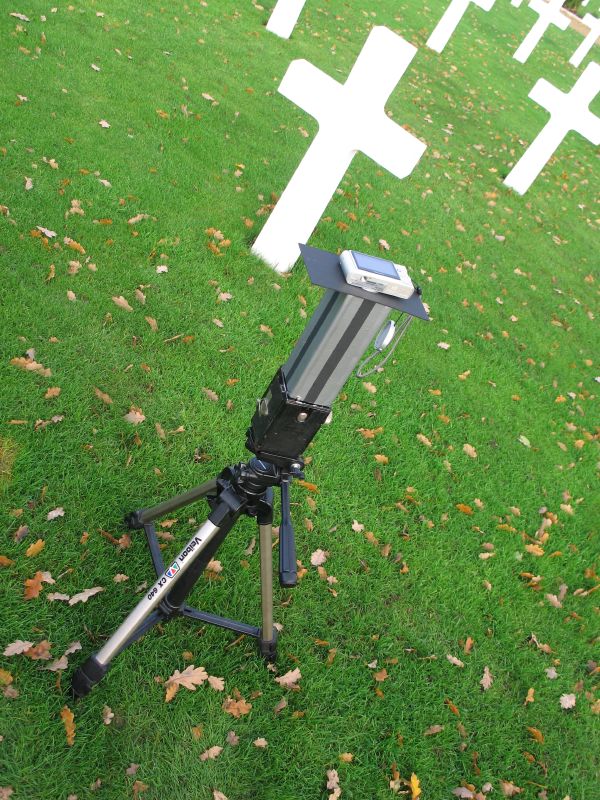 a large camera tripod in a field