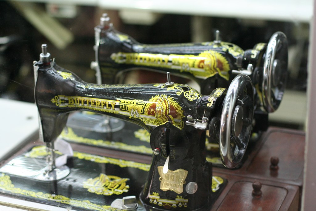 a close up of two black and yellow sewing machines