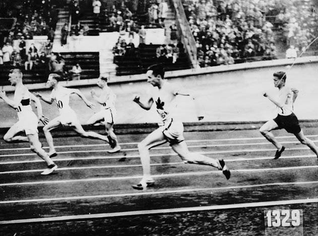 several boys on a track running around a circle