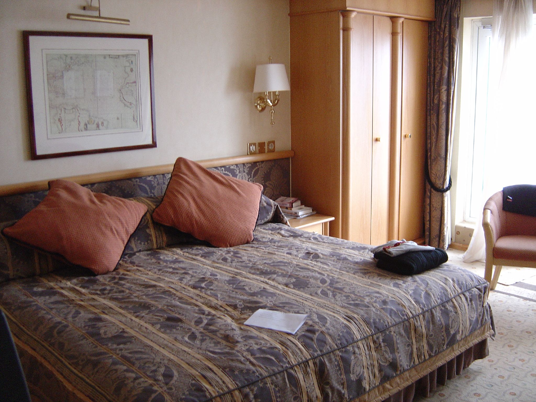 a el bed with a wooden head board