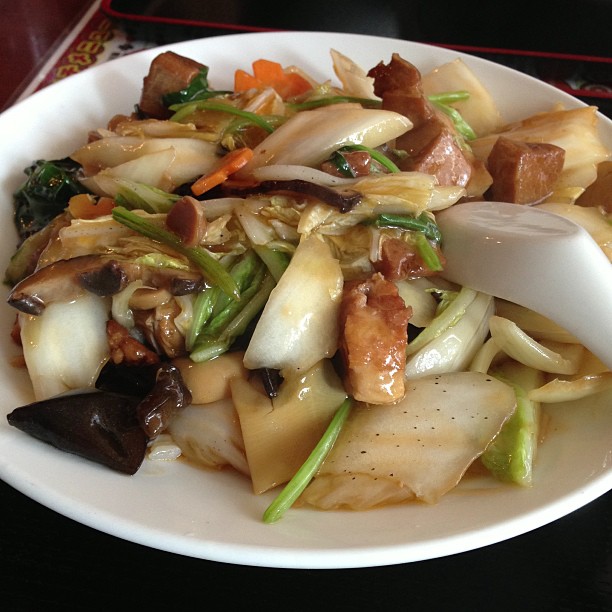 a white plate topped with stir fried vegetables