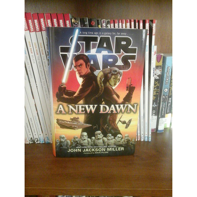 some books on the shelf with a star wars character