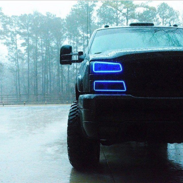 a large black suv parked in front of a parking lot