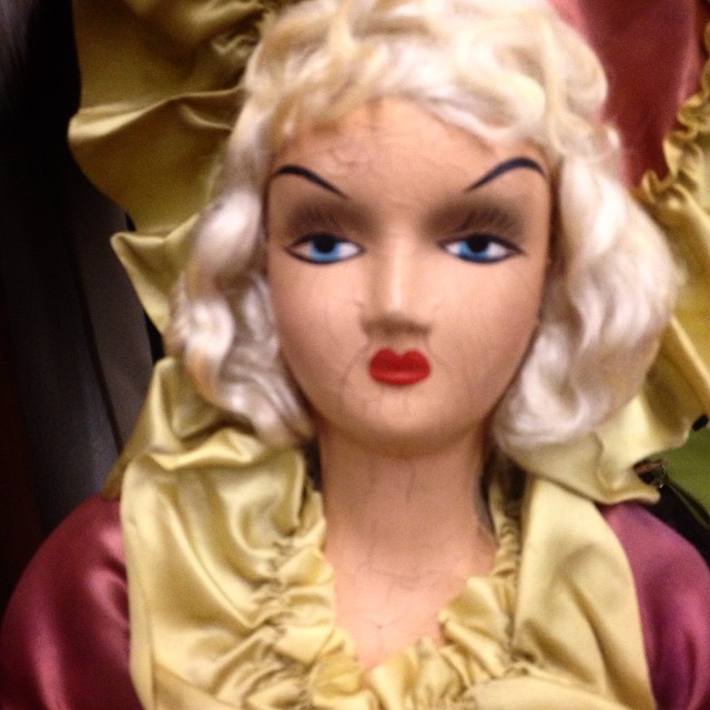 an old fashioned doll with hair blowing