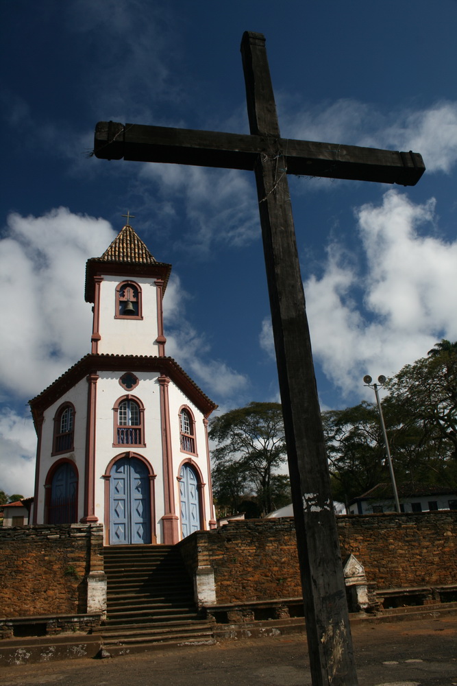 a wooden cross stands on the steps of a church