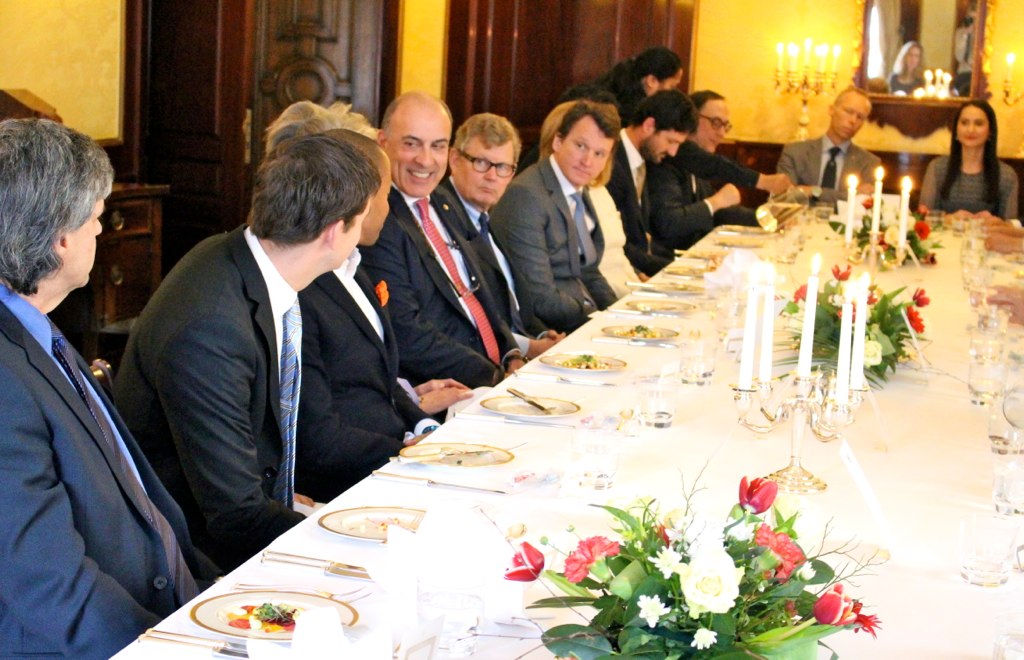the group of men sitting together at a long table