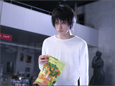 a man is holding a bag of chips