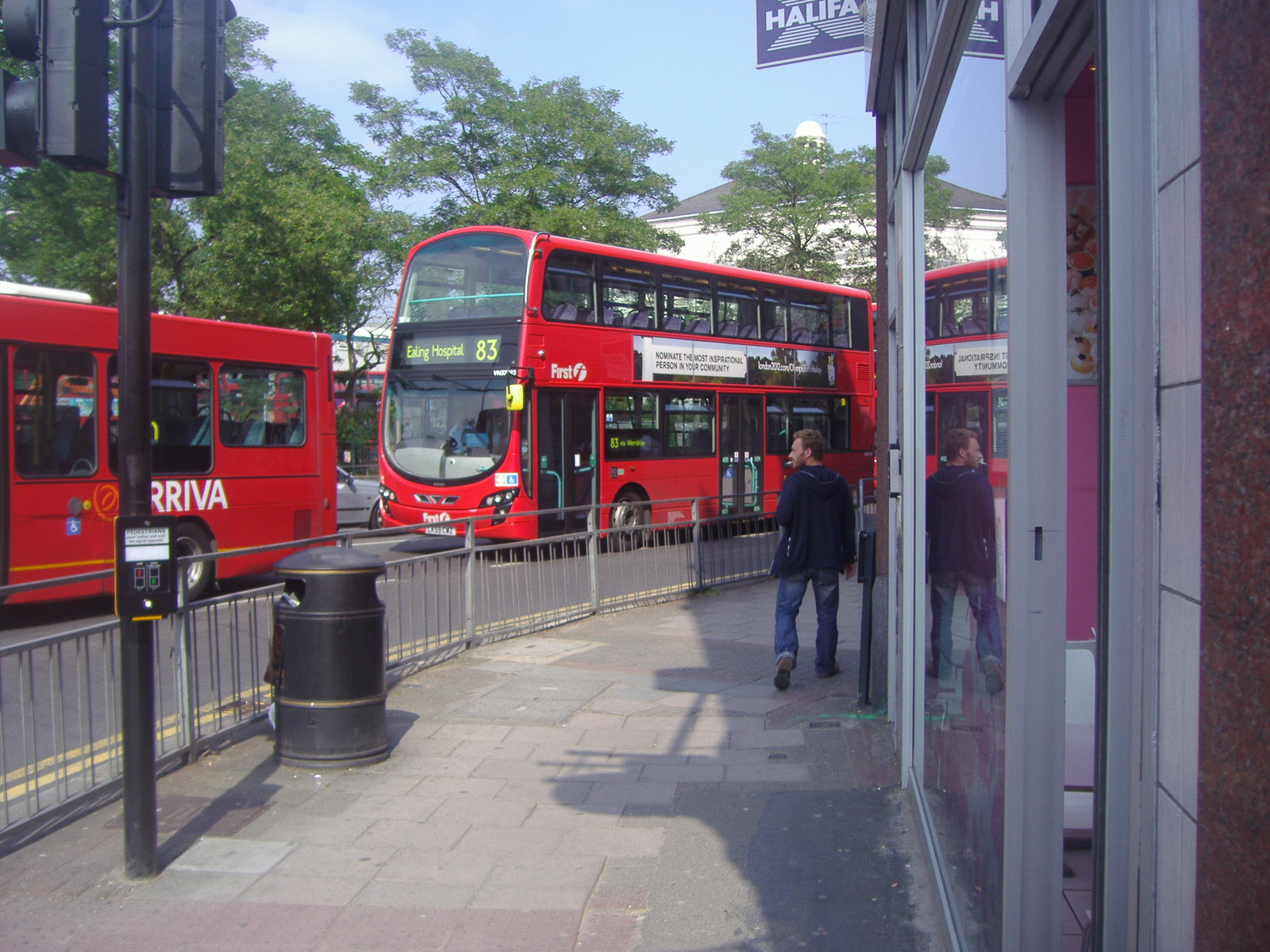 two red double decker buses parked in front of a building