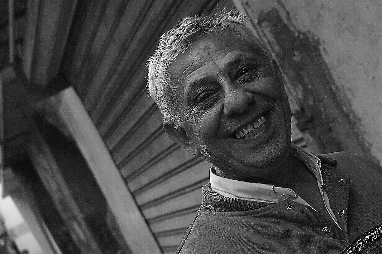 an elderly man smiling for the camera