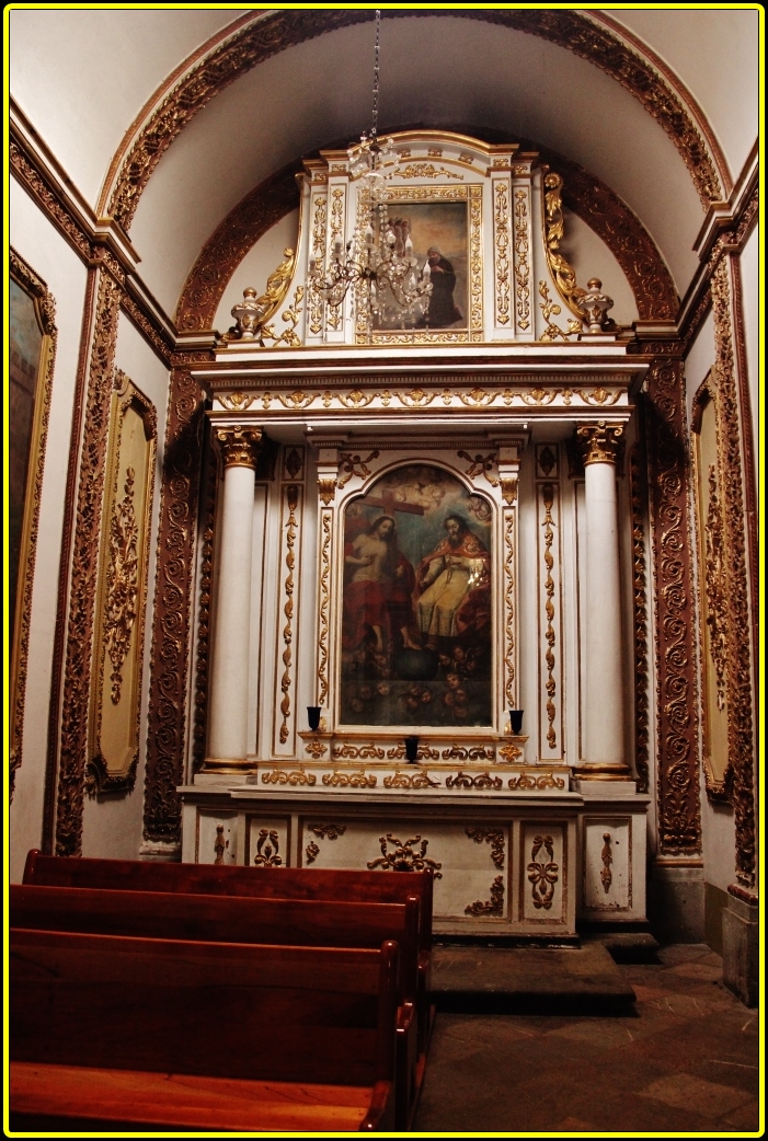 a church alter with paintings and decorations above