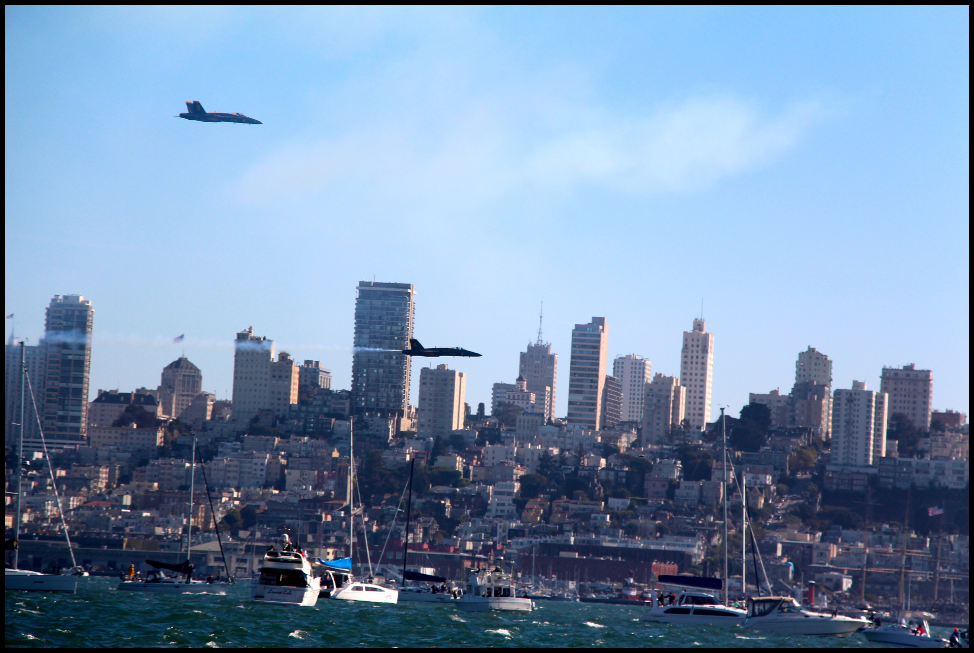 some ships and a large city on the water