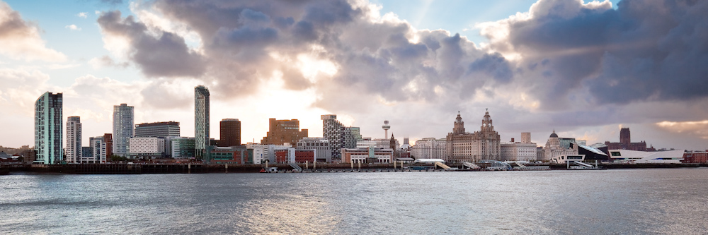 the sun shines brightly as it sets over a city skyline