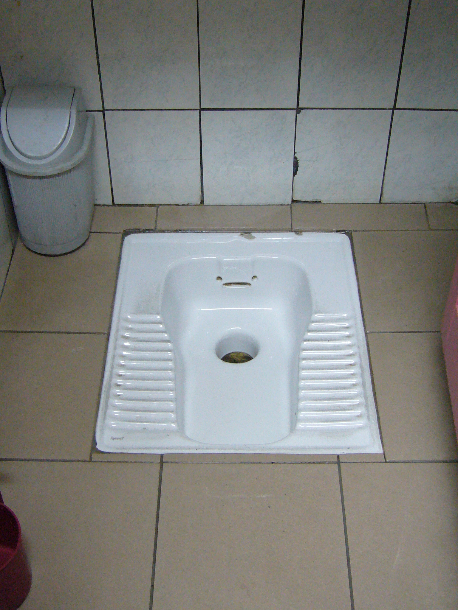 a small square white sink in a bathroom