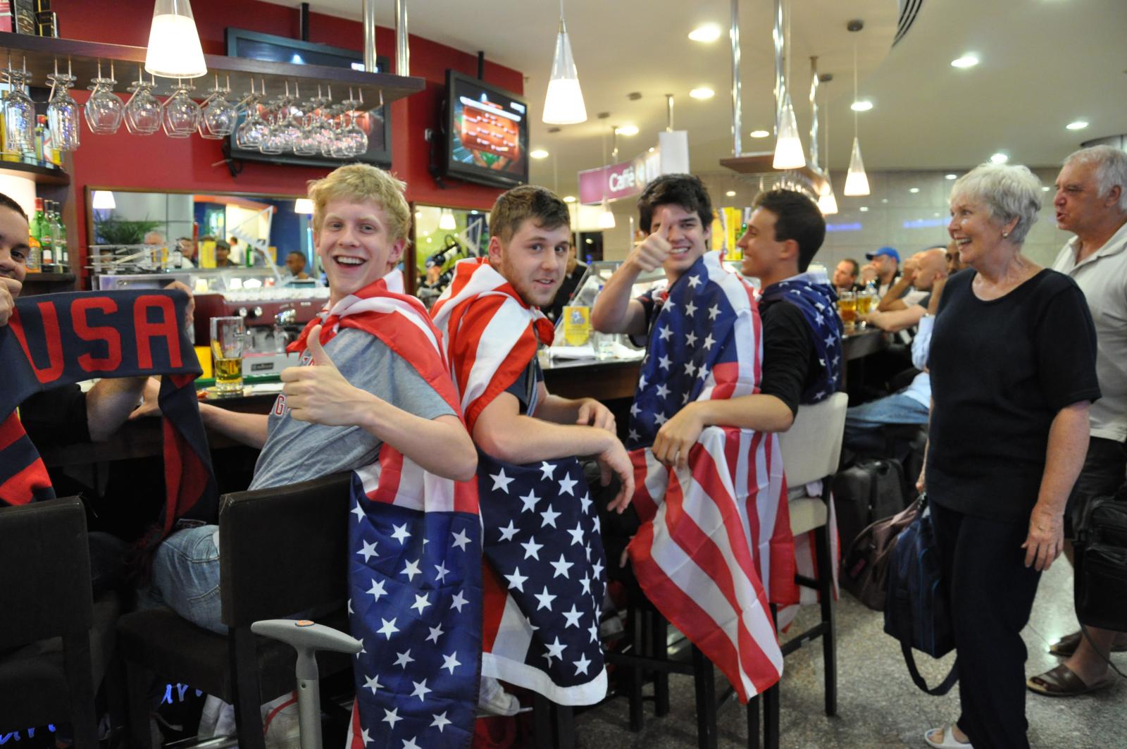 three men pose with us flags on their bodies