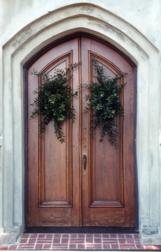 two door with three planters on top of them