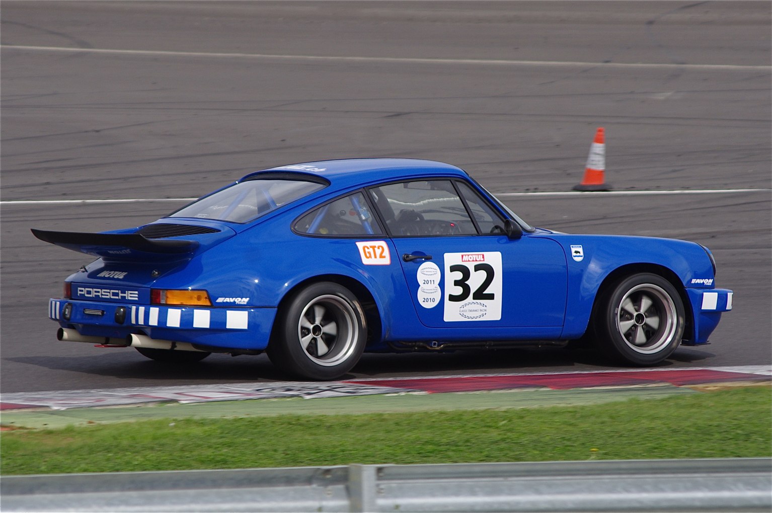 a blue race car going around a track