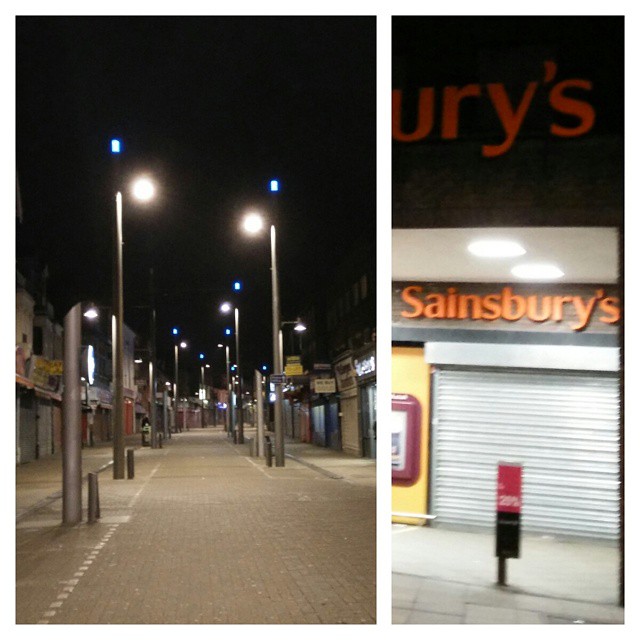 there are two different street lights next to a retail store