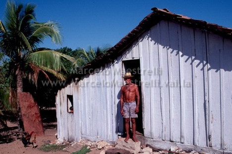 a man with  stands outside of a shed