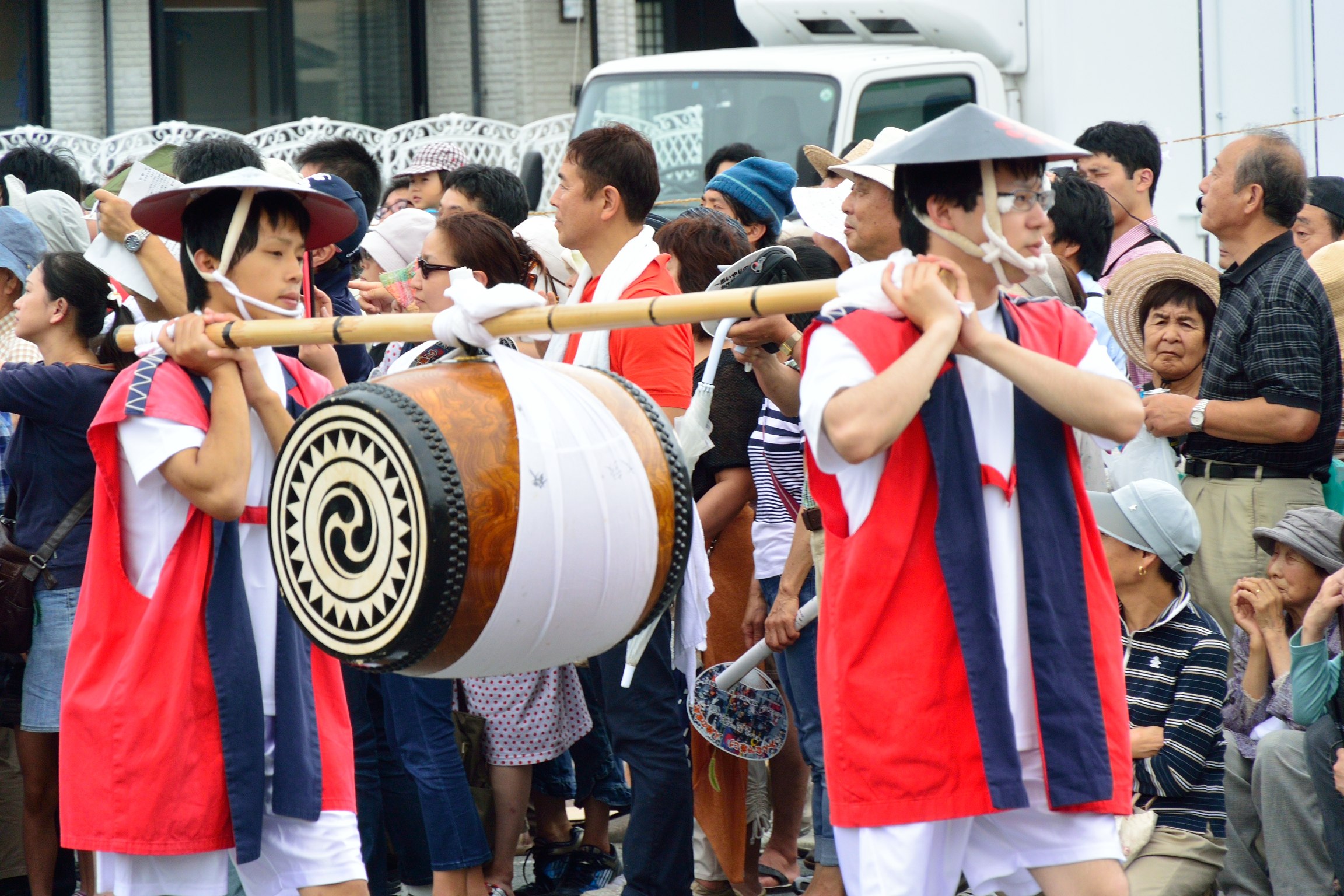 some people are walking in line and all carrying their musical instruments