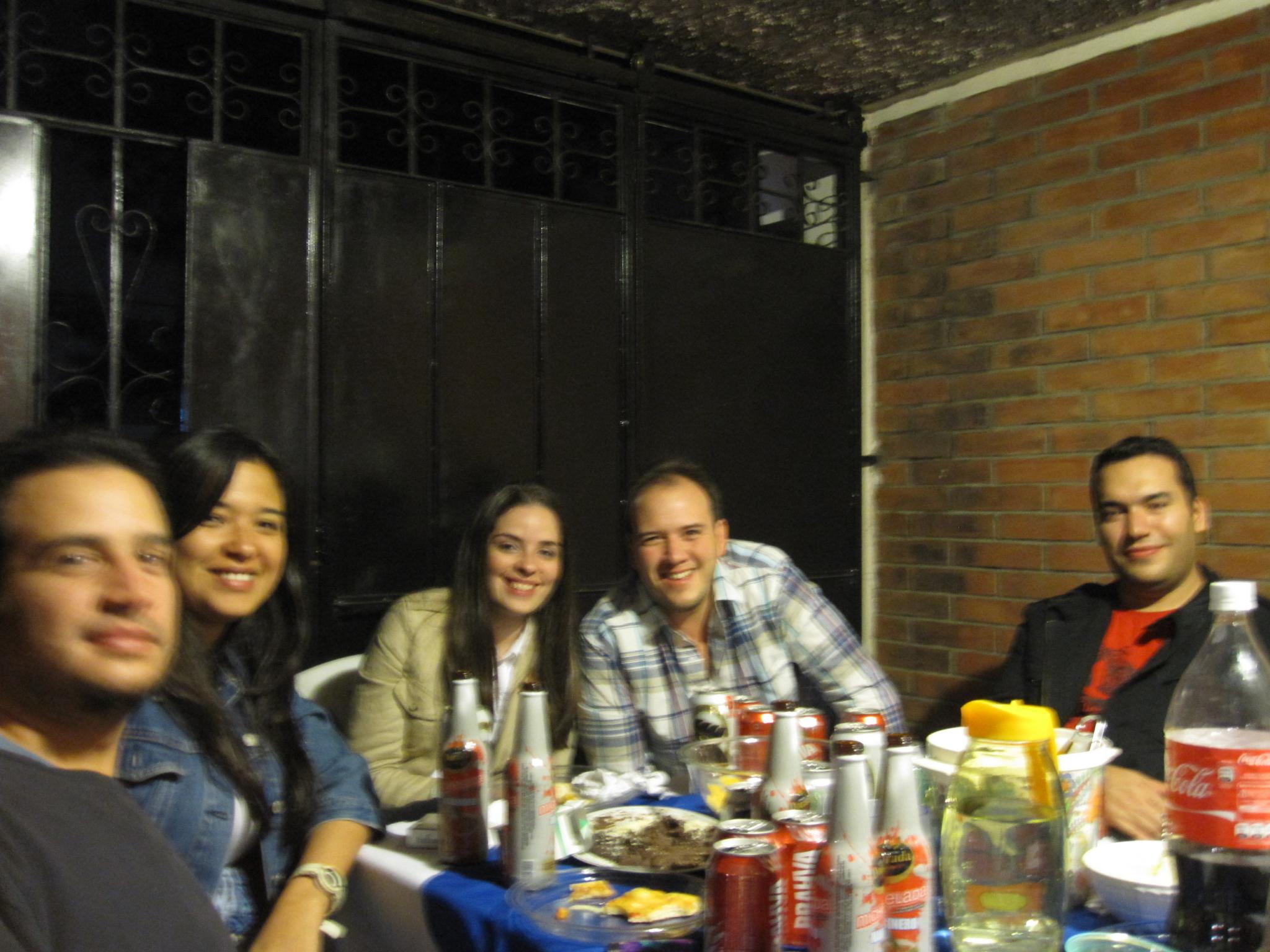 people sitting around a table with food and drinks